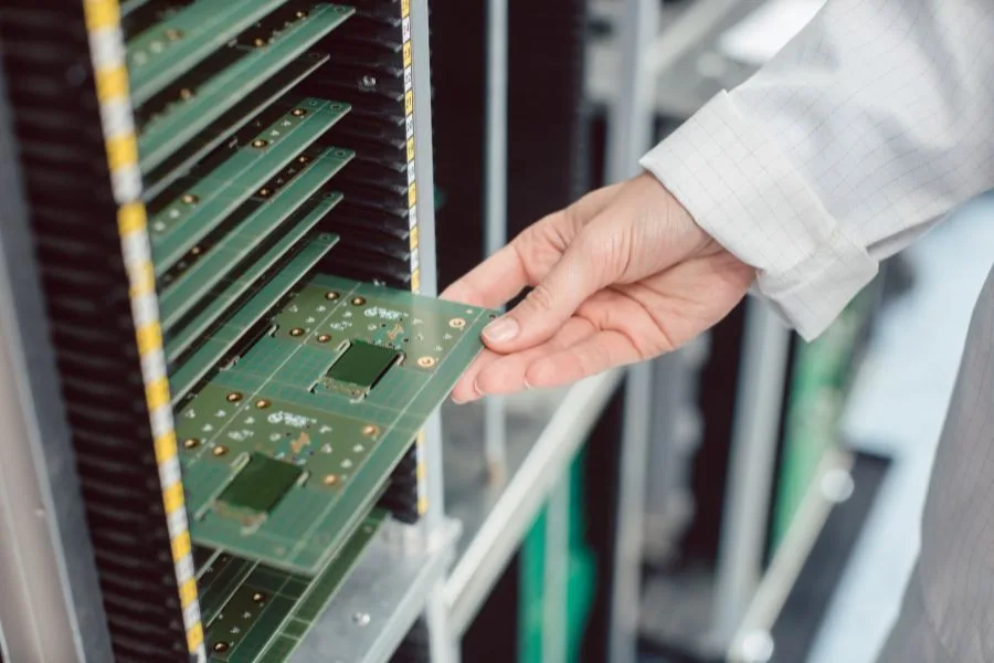 Electrical Engineer Performing Optical Inspection of PCB Boards During Electronic Assembly